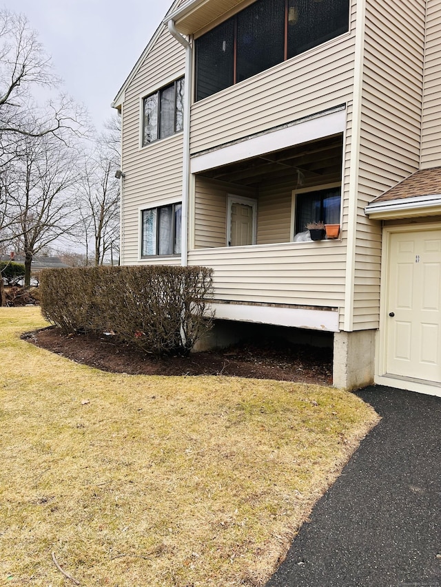 view of property exterior with a garage and a yard