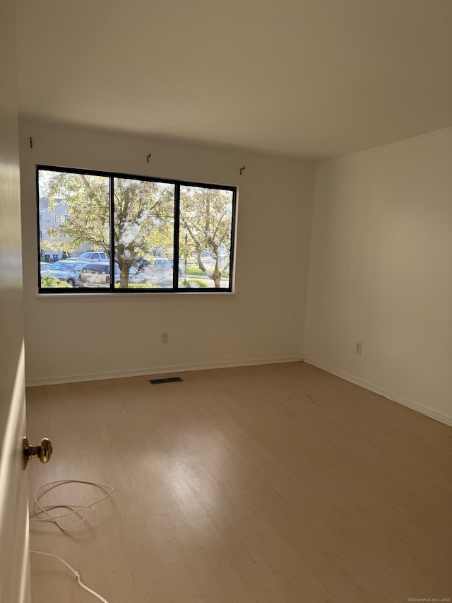 empty room with baseboards and visible vents