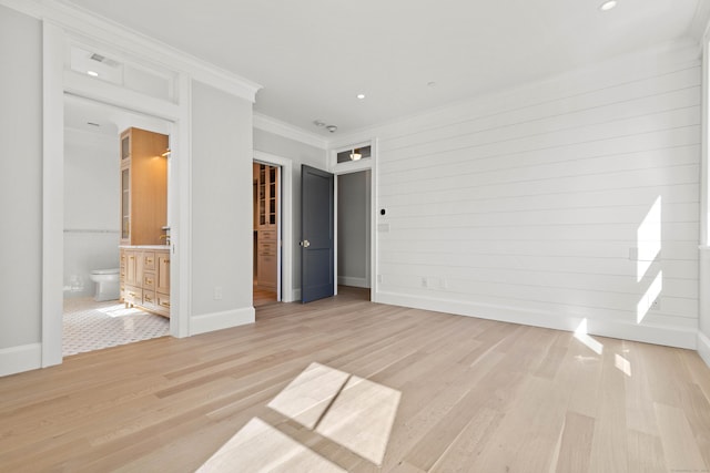 22 W Main St Unit 3, Groton, CT 06355 - unfurnished bedroom featuring crown molding, light wood-style floors, baseboards, ensuite bathroom, and a spacious closet