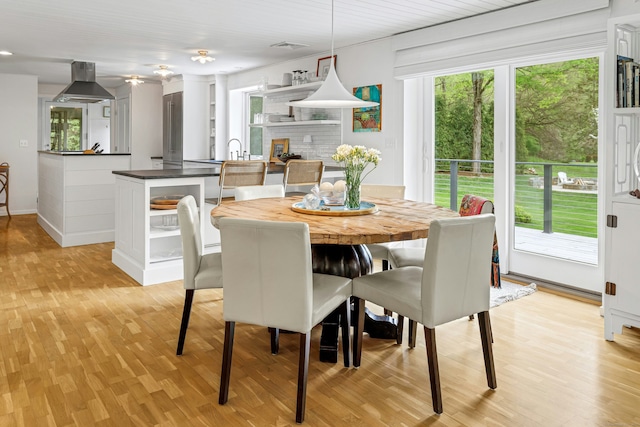 dining room featuring baseboards and light wood-style floors