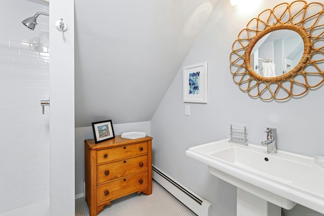 bathroom with curtained shower, vaulted ceiling, a baseboard radiator, and a sink