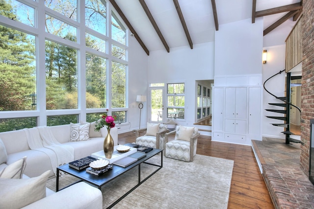 living area with high vaulted ceiling, wood-type flooring, and beam ceiling