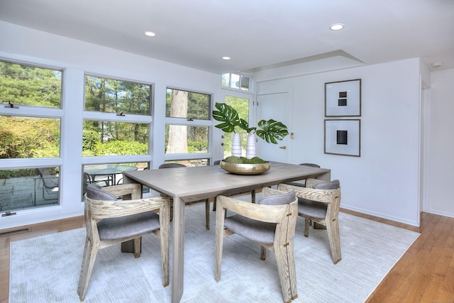 dining space featuring light wood-style flooring, recessed lighting, and baseboards