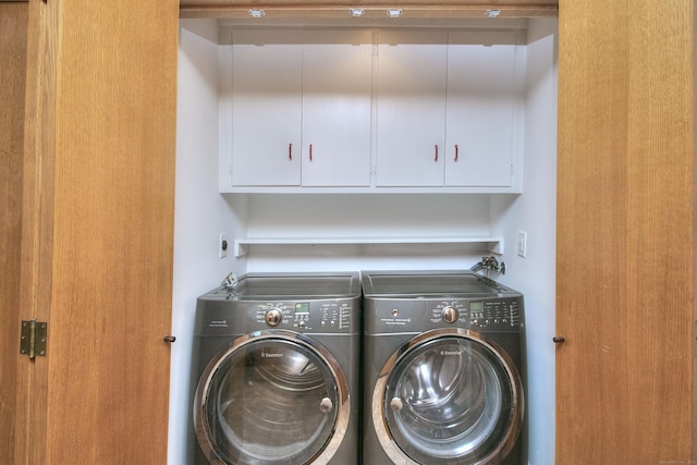 laundry room with cabinet space and washing machine and dryer