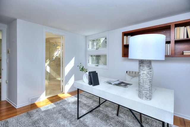 office space with wood finished floors and baseboards
