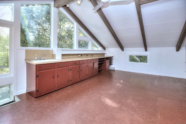 bonus room with a sink, dark floors, and baseboards