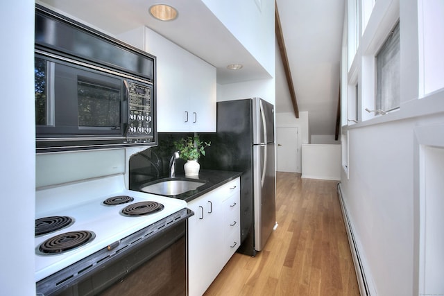 kitchen with baseboard heating, white cabinetry, a sink, and black microwave