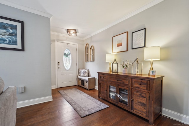 entrance foyer featuring dark wood finished floors, crown molding, and baseboards