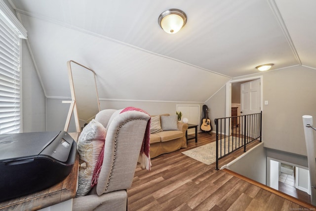 bonus room featuring vaulted ceiling and wood finished floors