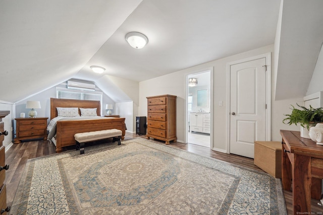 bedroom with lofted ceiling, wood finished floors, and an AC wall unit