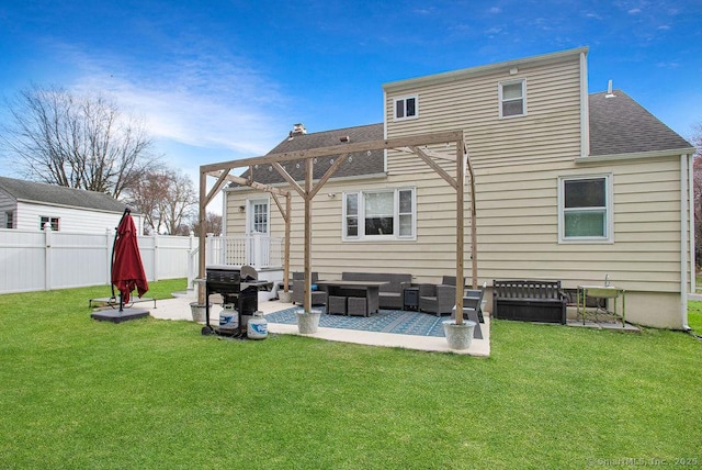 back of property featuring a lawn, a patio, fence, and roof with shingles