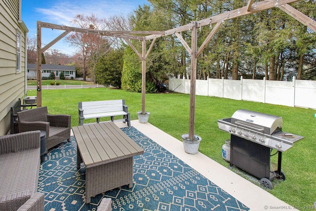 view of patio with a grill and fence
