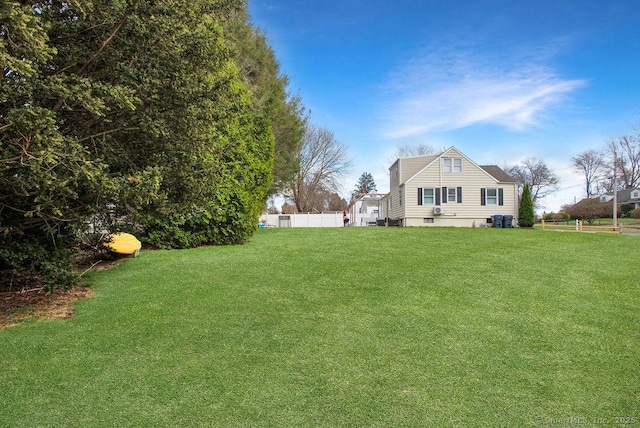 view of yard with fence and cooling unit