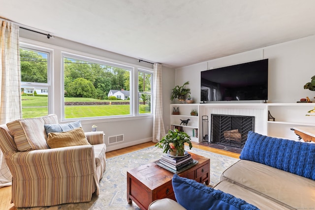 81 Beelzebub Rd, South Windsor, CT 06074 - living room featuring wood finished floors, a fireplace, and baseboards