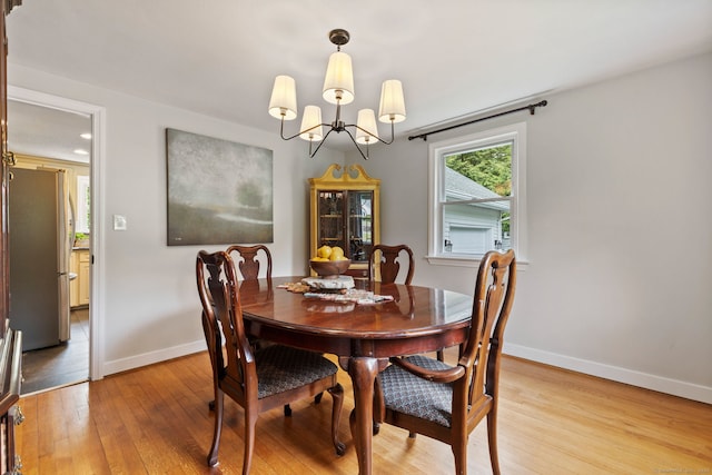 81 Beelzebub Rd, South Windsor, CT 06074 - dining area with light wood-style floors, a chandelier, and baseboards