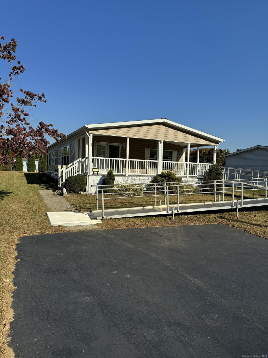 46 Lions Way, Windham, CT 06256 - manufactured / mobile home with a porch and fence