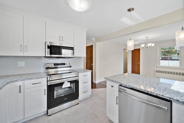 17 Lydall Rd, East Hartford, CT 06111 - kitchen with stainless steel appliances, backsplash, radiator, a chandelier, and white cabinetry