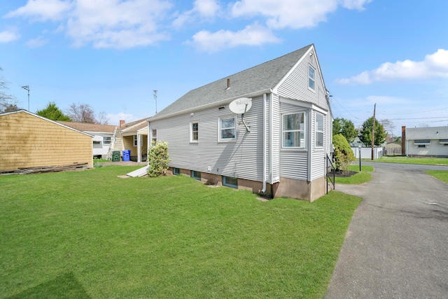 17 Lydall Rd, East Hartford, CT 06111 - back of house featuring a yard and roof with shingles