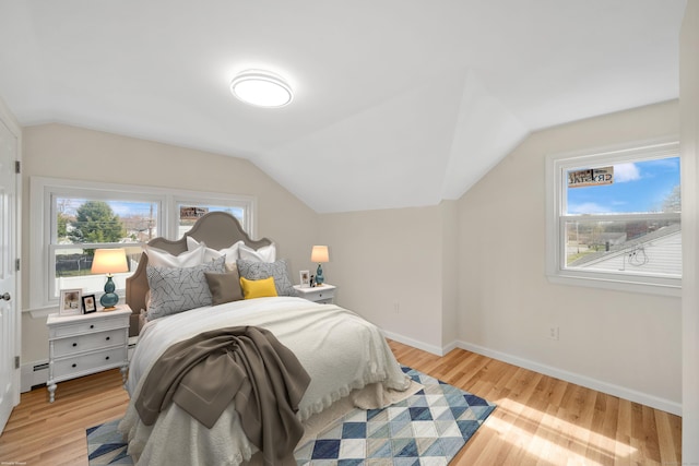 17 Lydall Rd, East Hartford, CT 06111 - bedroom with lofted ceiling, a baseboard radiator, light wood-style flooring, and baseboards