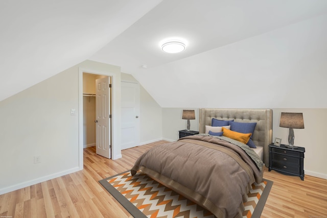 17 Lydall Rd, East Hartford, CT 06111 - bedroom with baseboards, light wood-style floors, vaulted ceiling, and a spacious closet