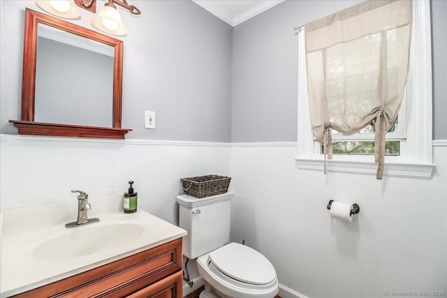 bathroom featuring toilet, crown molding, and vanity