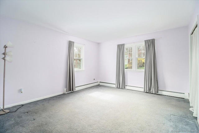 carpeted empty room featuring a healthy amount of sunlight and baseboards