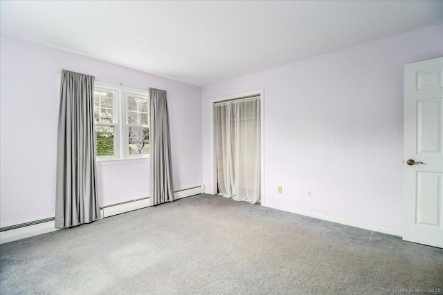 carpeted spare room featuring baseboards