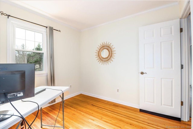 office area featuring light wood-style flooring, baseboards, and ornamental molding