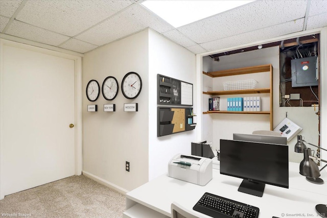 carpeted office space with a paneled ceiling, electric panel, and baseboards