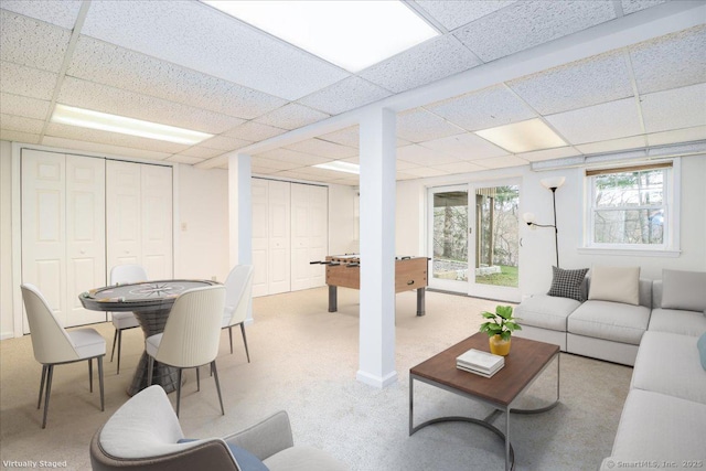 carpeted living room with a paneled ceiling
