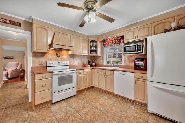 kitchen with premium range hood, a sink, light brown cabinets, and white appliances