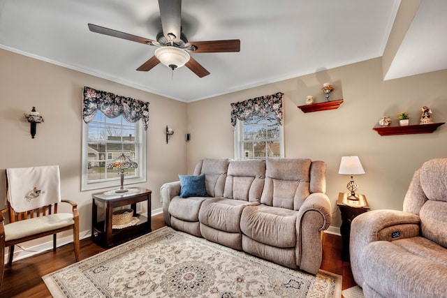 living room featuring baseboards, wood finished floors, ceiling fan, and ornamental molding