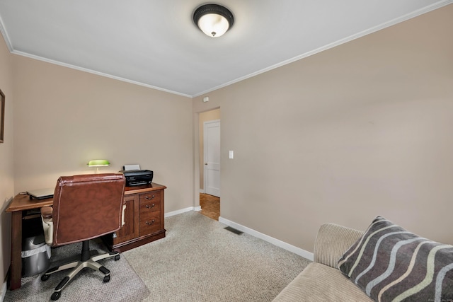 carpeted home office featuring crown molding, visible vents, and baseboards