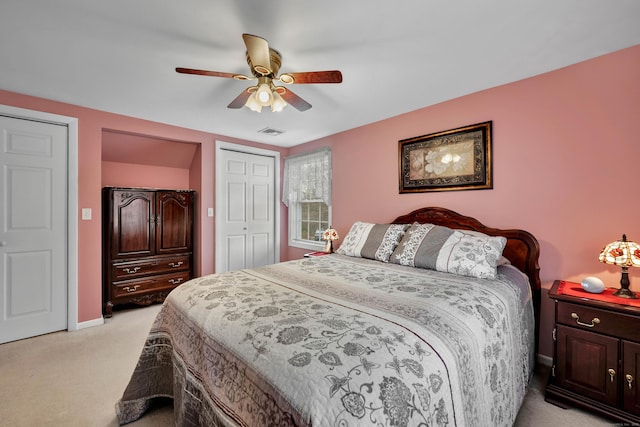 bedroom featuring a closet, ceiling fan, visible vents, light carpet, and baseboards