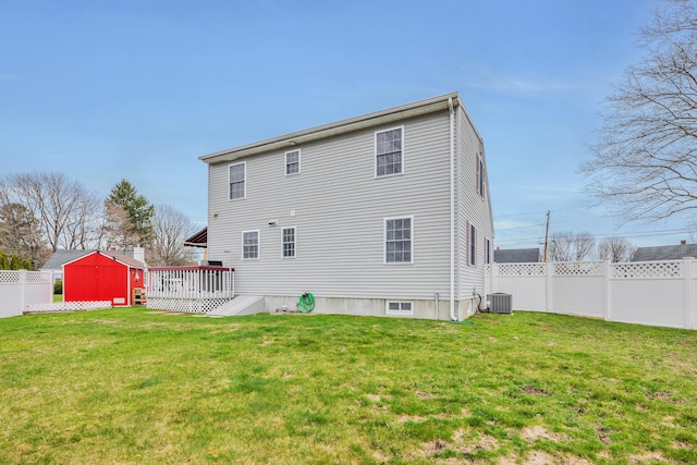 back of house featuring cooling unit, a wooden deck, a yard, and a fenced backyard