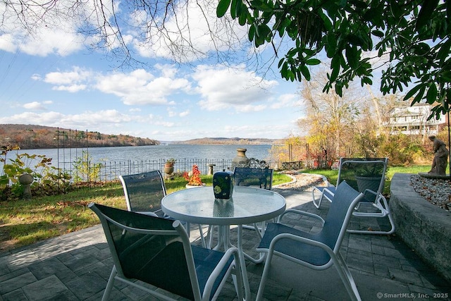 77 Main St, East Haddam, CT 06423 - view of patio featuring outdoor dining space, a water view, and fence