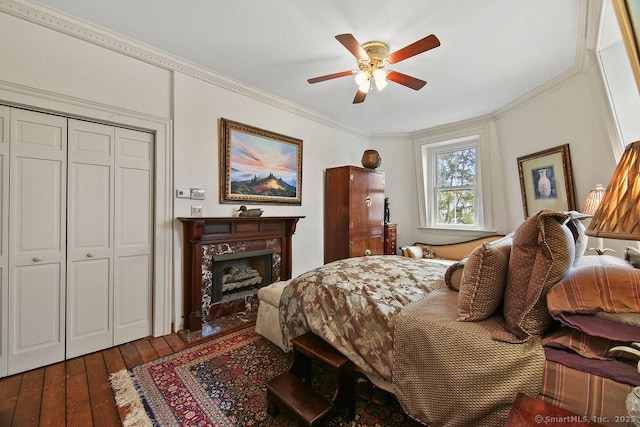 77 Main St, East Haddam, CT 06423 - bedroom featuring wood-type flooring, ornamental molding, a closet, a premium fireplace, and a ceiling fan