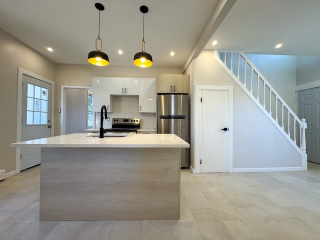 kitchen featuring modern cabinets, white cabinets, appliances with stainless steel finishes, light countertops, and a sink