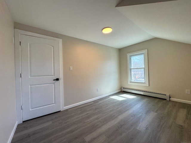interior space with dark wood-style flooring, a baseboard radiator, and baseboards