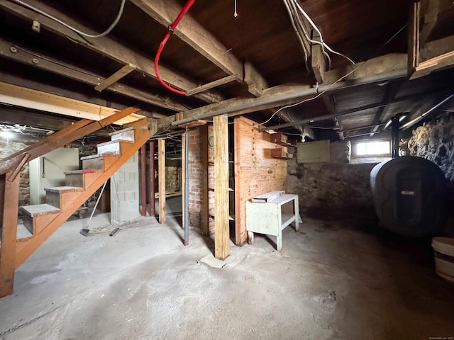 below grade area featuring heating fuel and stairway
