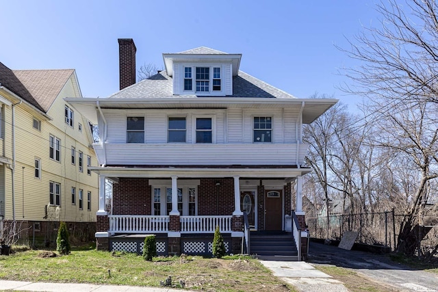 67-69 Sterling St, Hartford, CT 06154 - american foursquare style home with a front yard, covered porch, a chimney, fence, and brick siding