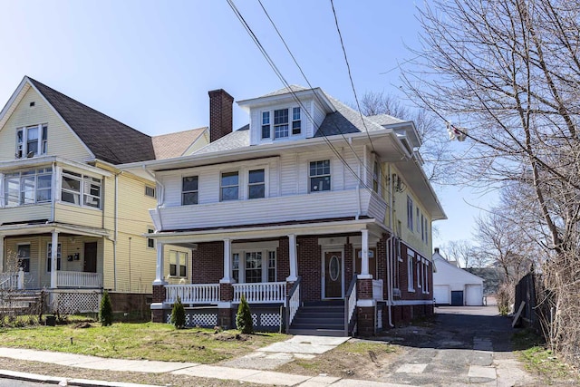 67-69 Sterling St, Hartford, CT 06154 - traditional style home featuring an outbuilding, a detached garage, a porch, brick siding, and a chimney
