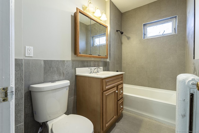 67-69 Sterling St, Hartford, CT 06154 - bathroom featuring vanity, a wainscoted wall, toilet, shower / bathtub combination, and tile walls