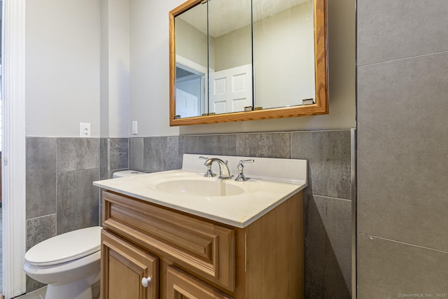 67-69 Sterling St, Hartford, CT 06154 - bathroom featuring vanity, tile walls, toilet, and wainscoting
