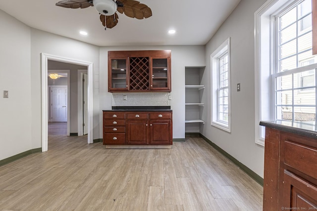 67-69 Sterling St, Hartford, CT 06154 - kitchen featuring glass insert cabinets, baseboards, ceiling fan, dark countertops, and light wood-style floors
