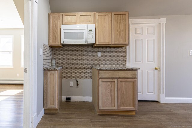67-69 Sterling St, Hartford, CT 06154 - kitchen featuring white microwave, a baseboard heating unit, light brown cabinetry, and dark wood finished floors