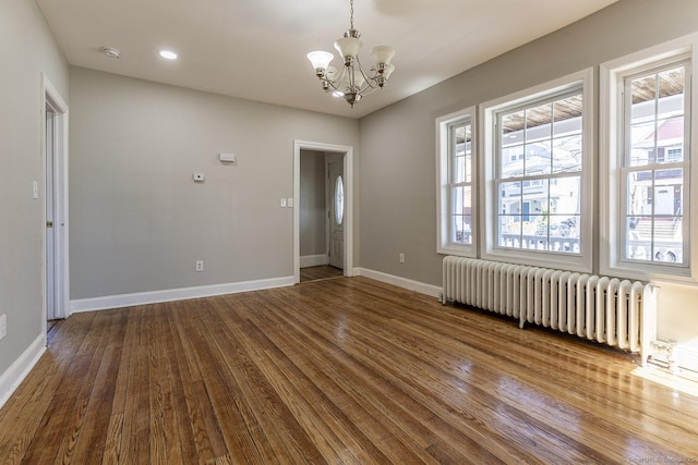 67-69 Sterling St, Hartford, CT 06154 - empty room featuring radiator, a notable chandelier, dark wood finished floors, and baseboards
