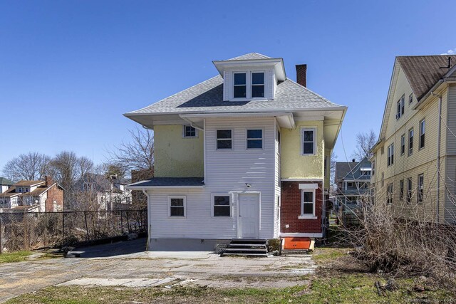 67-69 Sterling St, Hartford, CT 06154 - rear view of property with entry steps, fence, a shingled roof, and a chimney