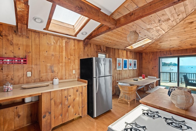 0 Burr Is, Branford, CT 06405 - kitchen with light wood-style flooring, wood walls, vaulted ceiling with skylight, wood ceiling, and freestanding refrigerator