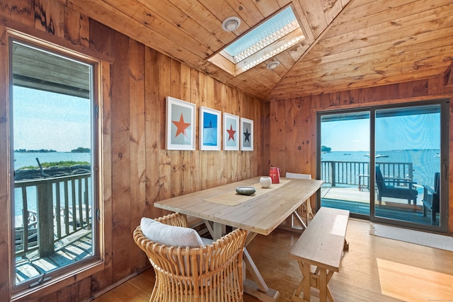 0 Burr Is, Branford, CT 06405 - dining space featuring lofted ceiling with skylight, wood ceiling, wooden walls, and wood finished floors
